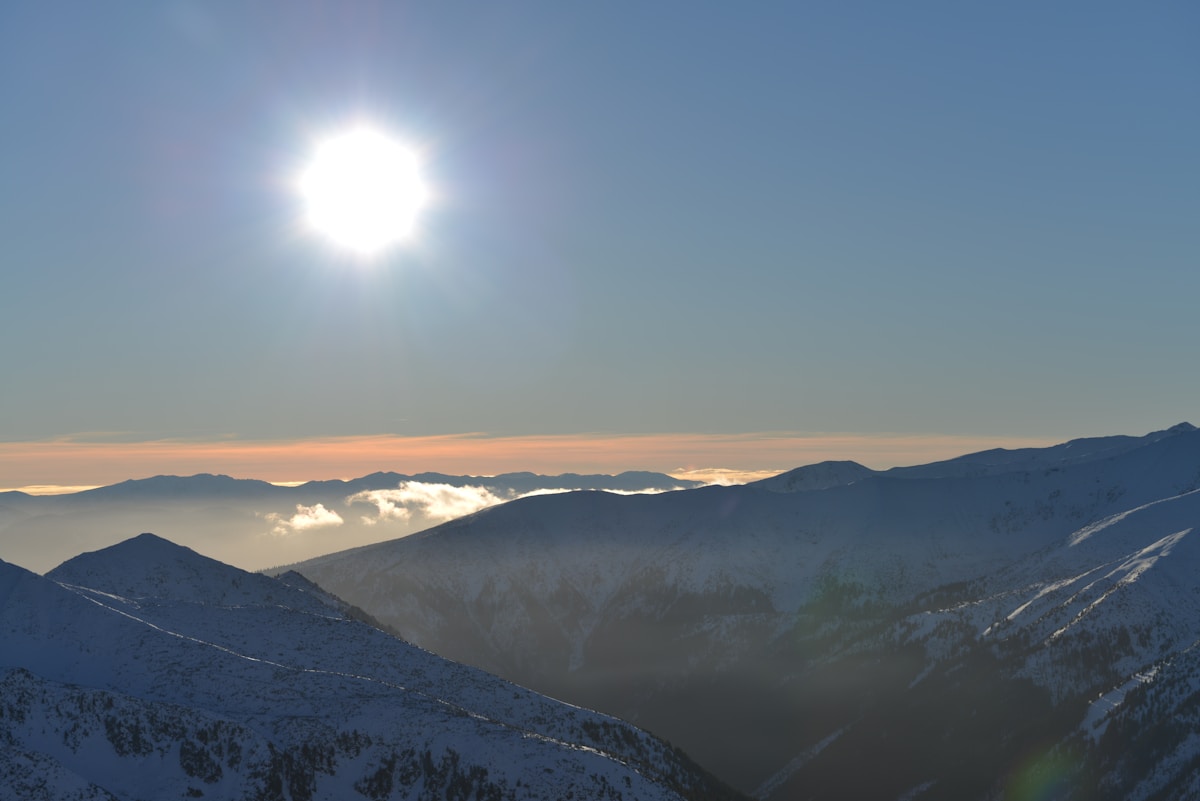 Snow-covered mountain ridges and peaks in southern Poland at sunset, gateway to the Karkonosze range