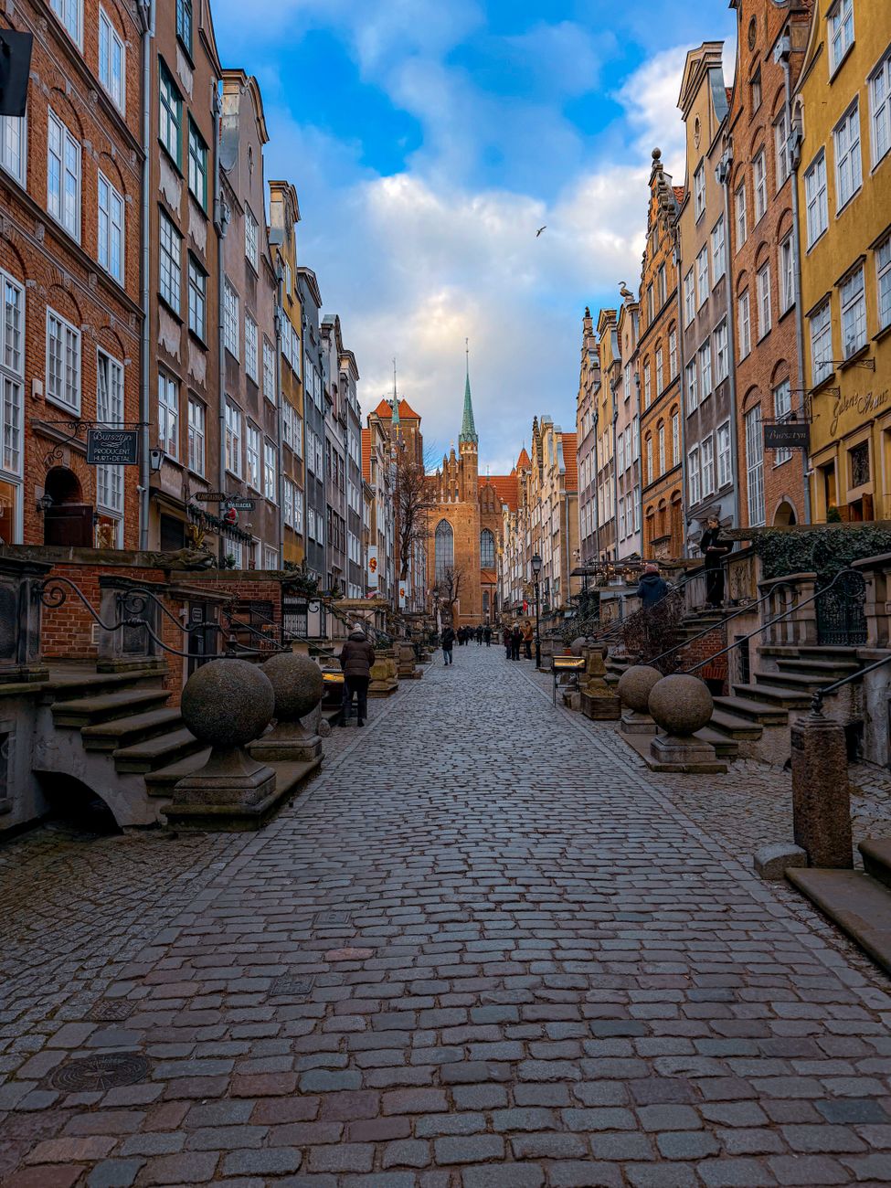 Long Lane (Długa) cobblestone street in Gdańsk Old Town with St. Mary's Church in the distance