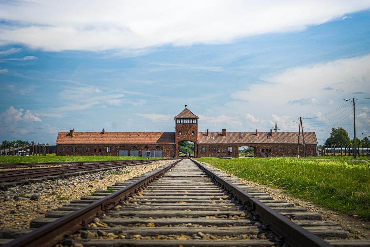 Train tracks leading to the entrance gate of Auschwitz-Birkenau concentration camp, Poland