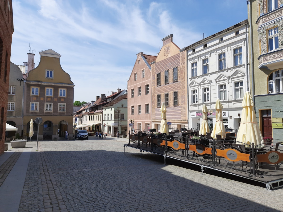Olsztyn Old Town Market Square with outdoor restaurant terraces and colourful burgher houses, Warmia-Masuria, Poland