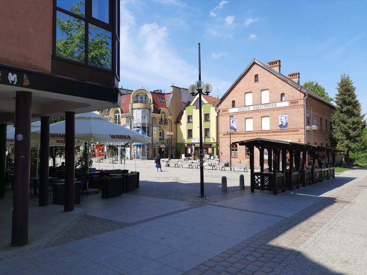 Town square with café terraces and GAZETA OLSZTYŃSKA building in Olsztyn Old Town, Warmia-Masuria, Poland