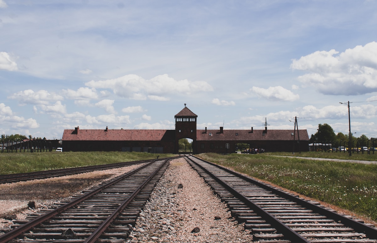 Railway tracks leading to the Auschwitz II-Birkenau gate and watchtower memorial site, Oświęcim, Poland
