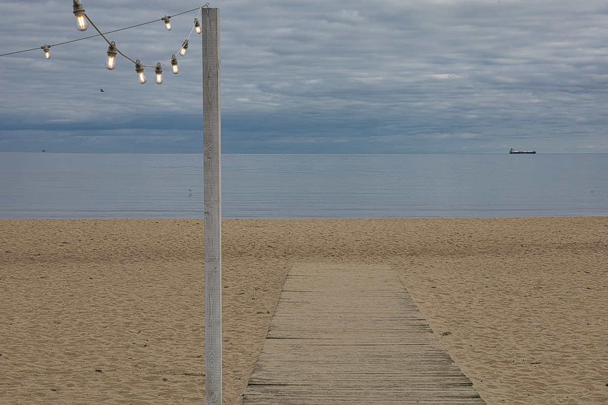 Wooden boardwalk path leading to the Baltic Sea beach in Sopot, Poland