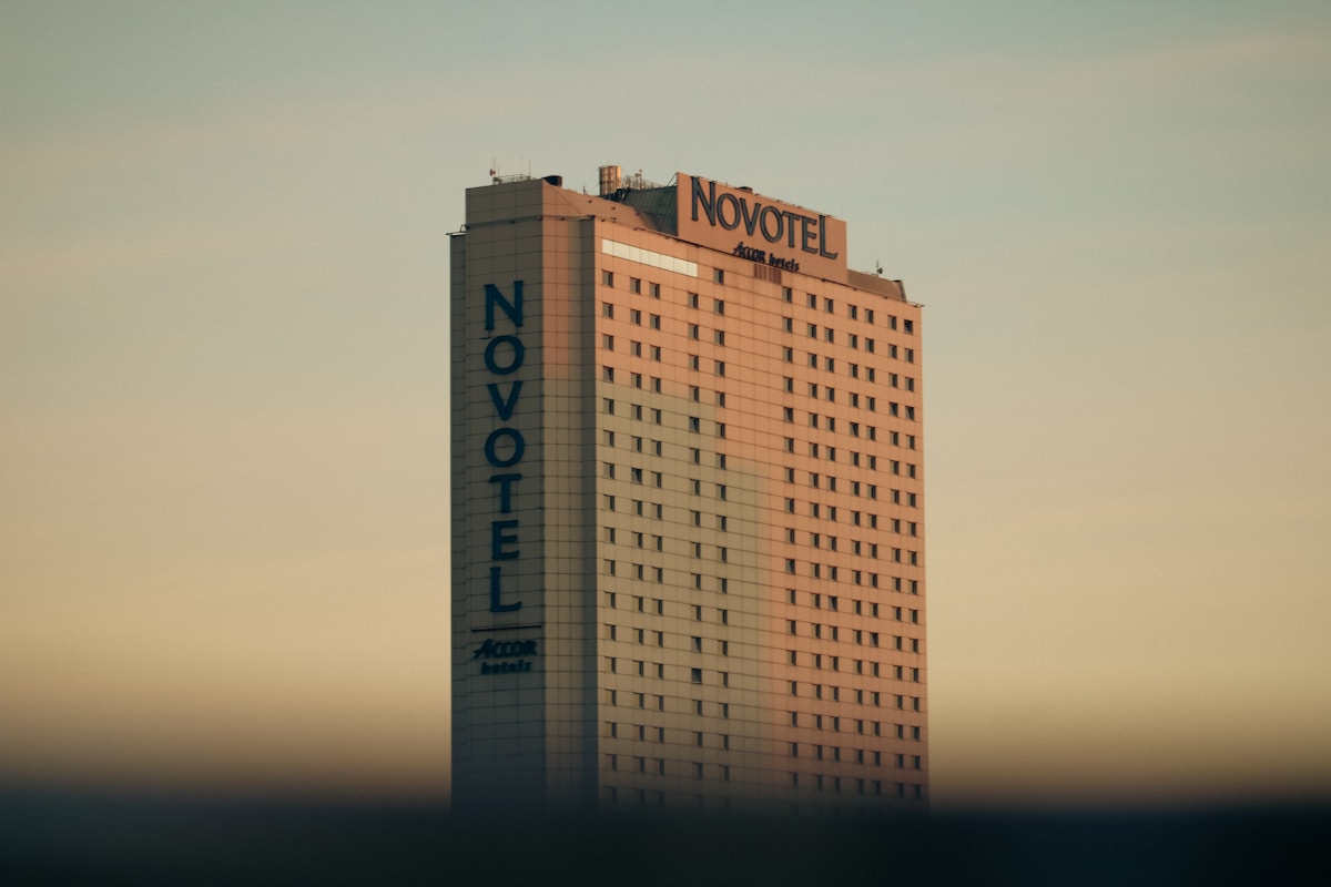 Novotel hotel tower in Warsaw against an evening sky