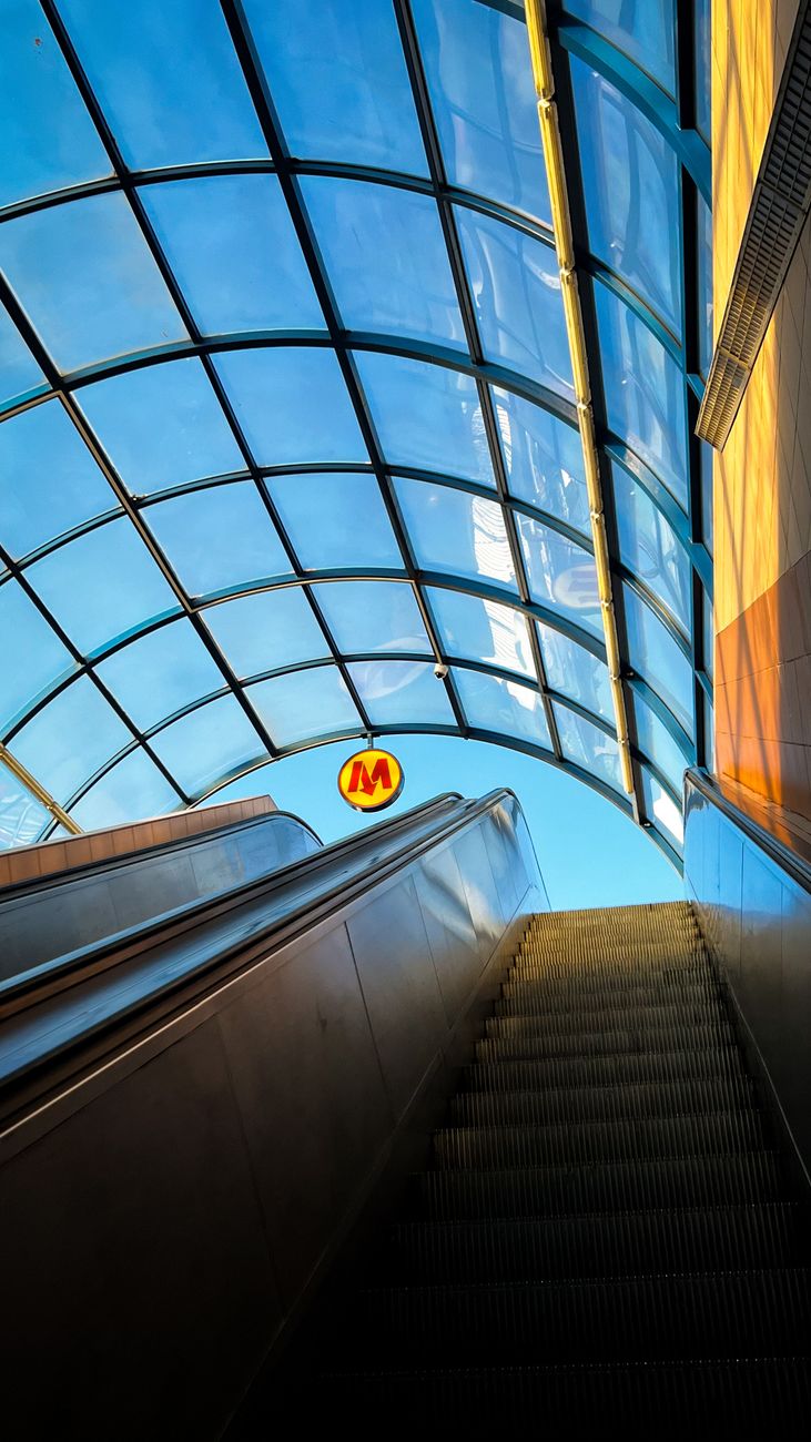 Warsaw metro escalator with the Metro M logo at a central station