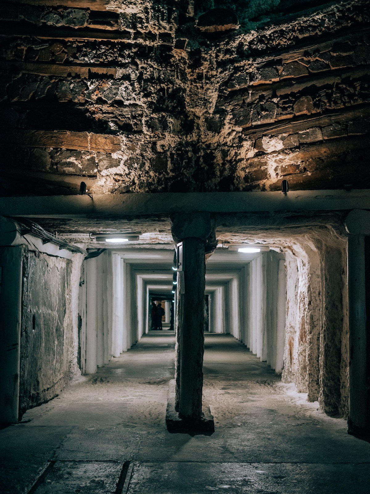 Long tunnel with salt-encrusted walls deep underground in the Wieliczka Salt Mine, Poland