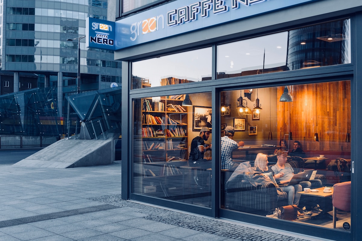 Modern coworking space interior in Kraków with open desks and laptop workers, Poland