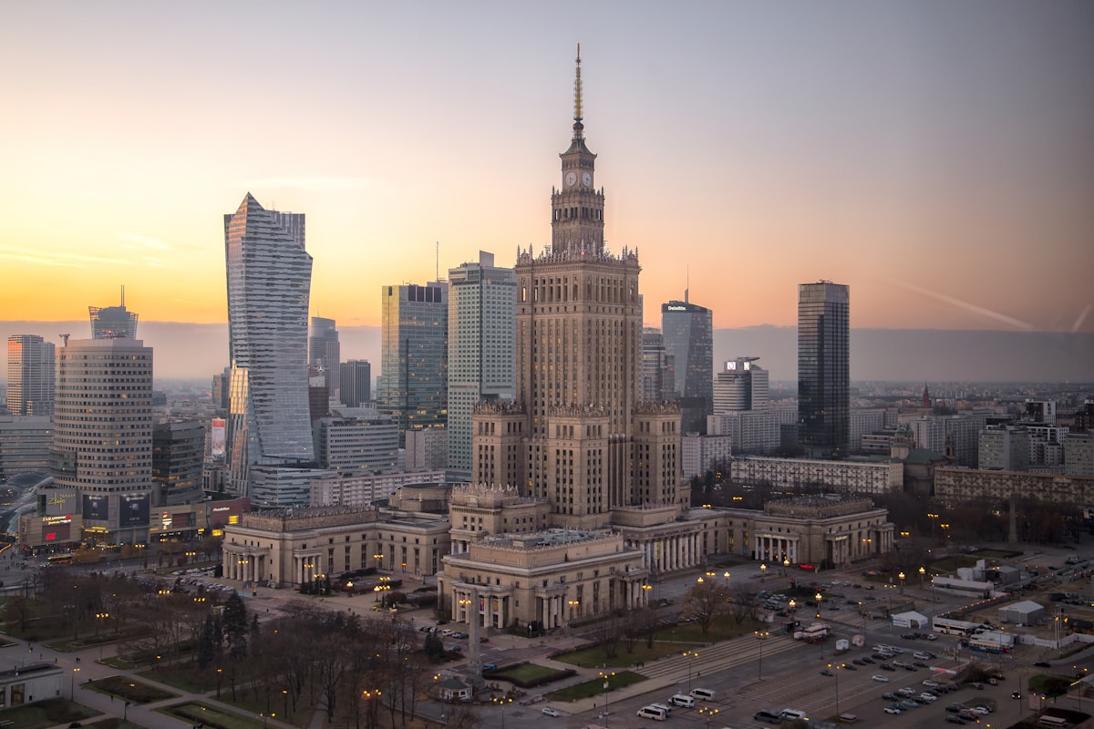Warsaw skyline with the Palace of Culture and modern skyscrapers at sunset, Poland