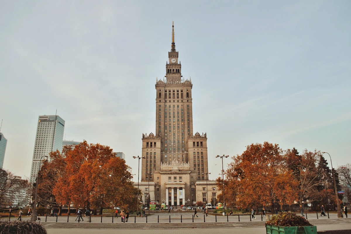 Palace of Culture and Science in Warsaw surrounded by autumn orange foliage, October