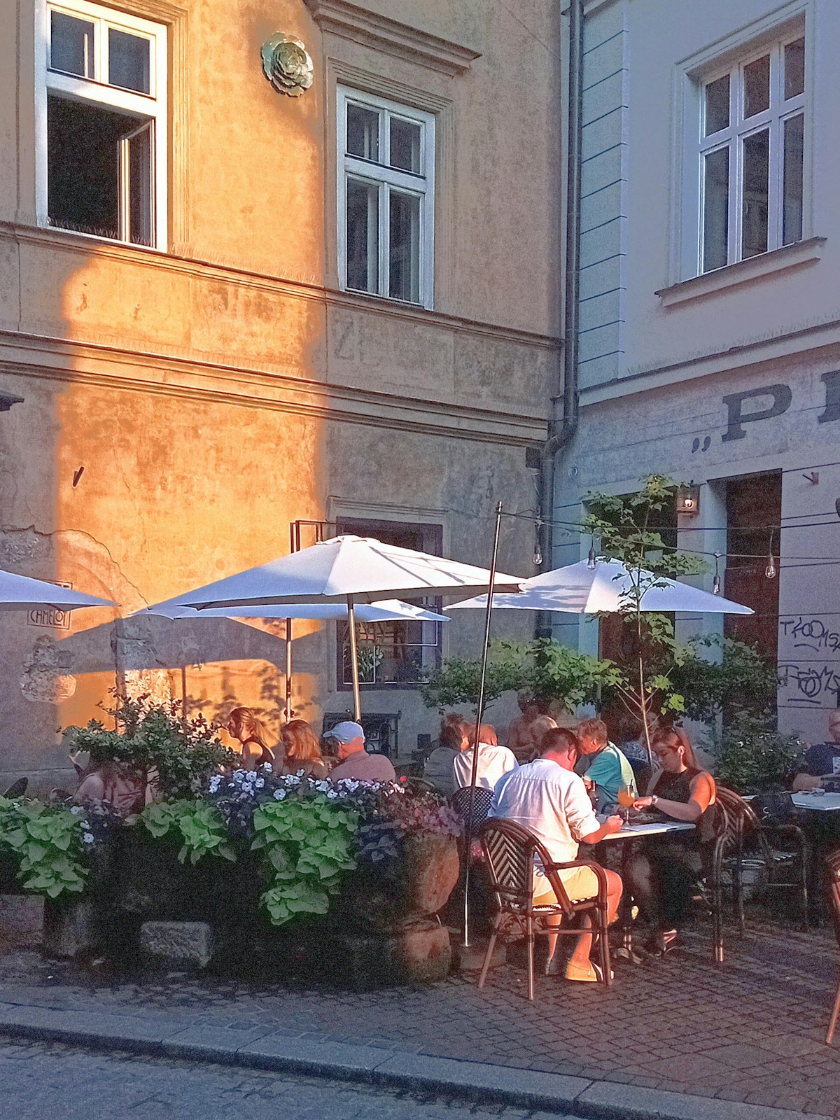 Kraków restaurant terrace with stone arch and evening candle lighting