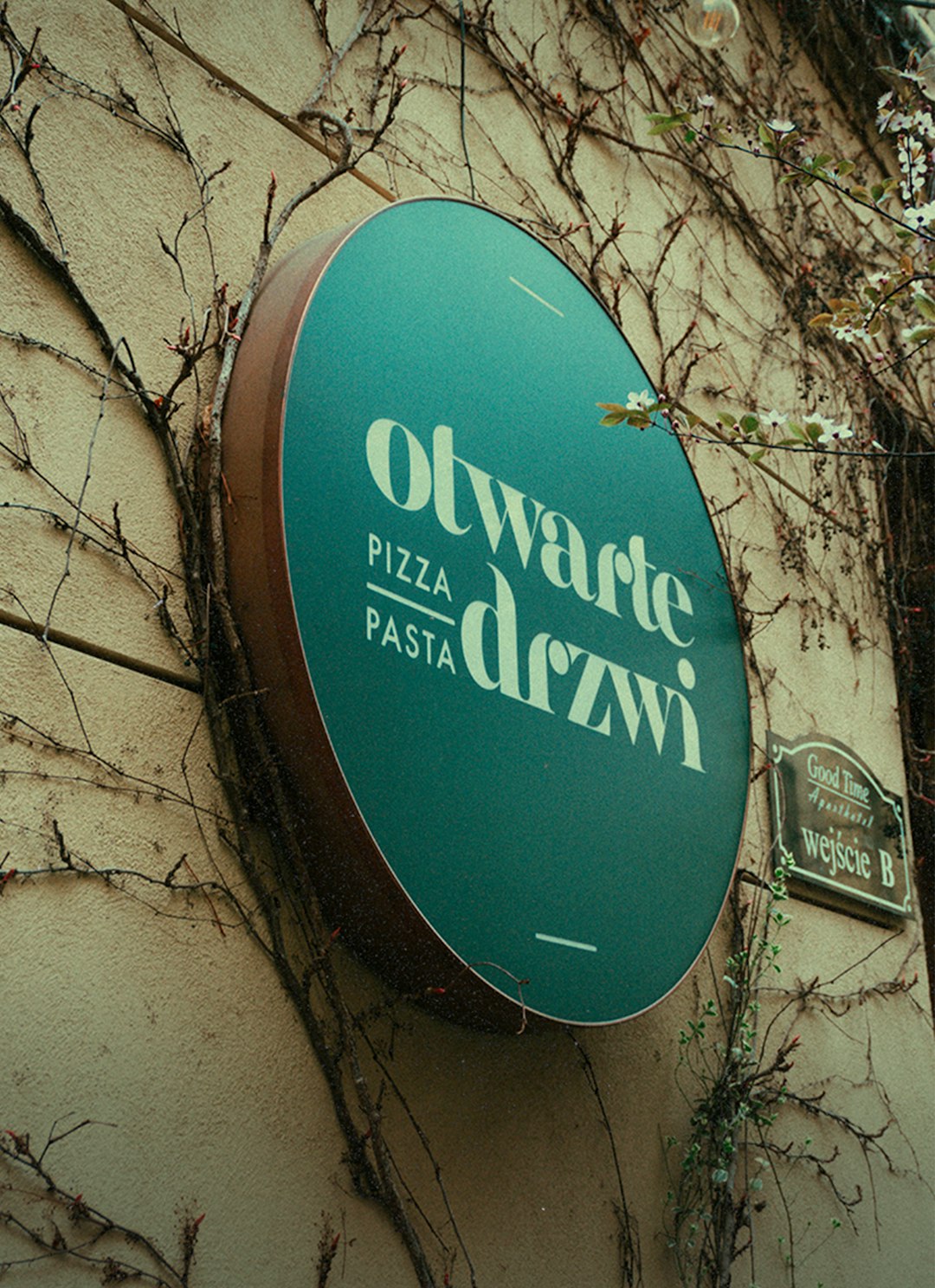 Restaurant sign for Otwarte Drzwi pizza and pasta in Łódź, Poland