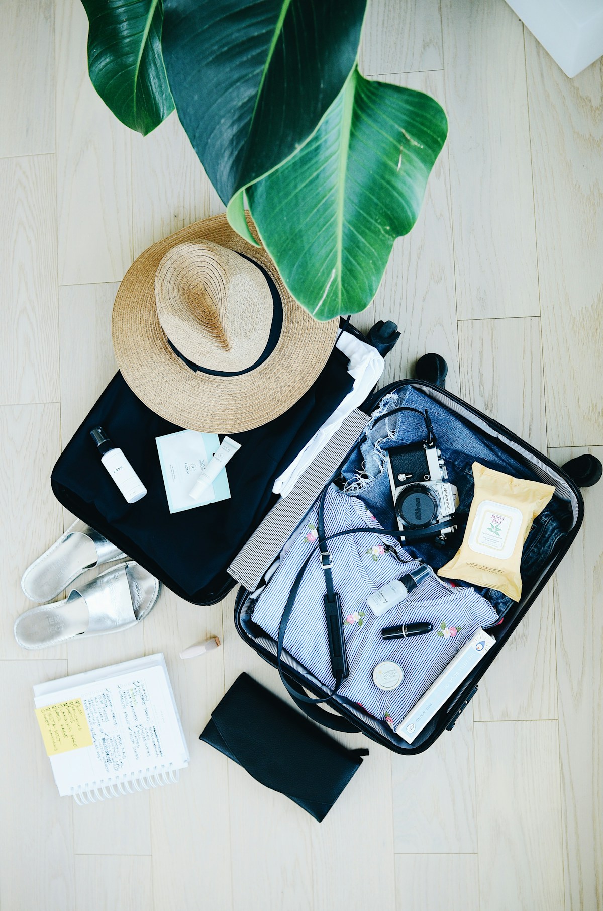 Open suitcase with clothes and essentials laid out for a Poland trip