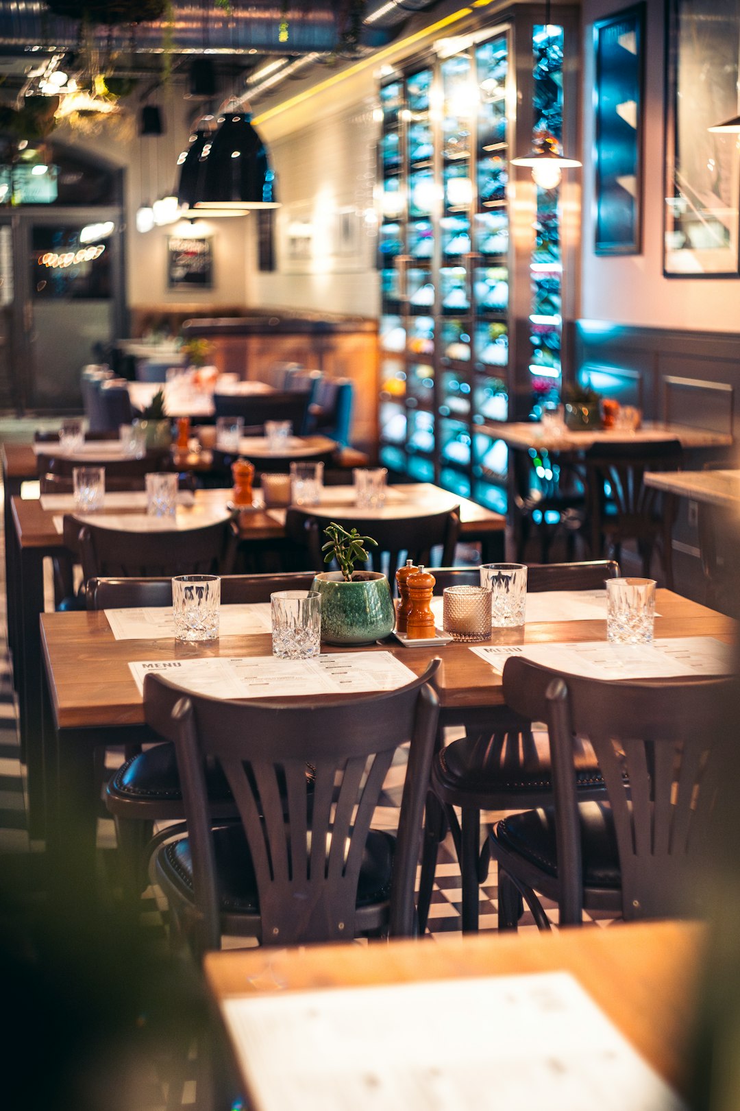 Modern restaurant interior with wooden tables and warm lighting in Poznań, Poland