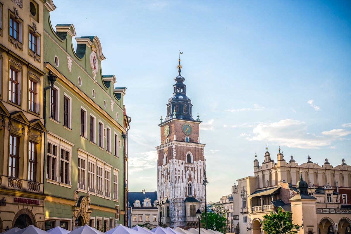 Kraków's Main Market Square with the Town Hall Tower and Cloth Hall under a summer sky, Poland