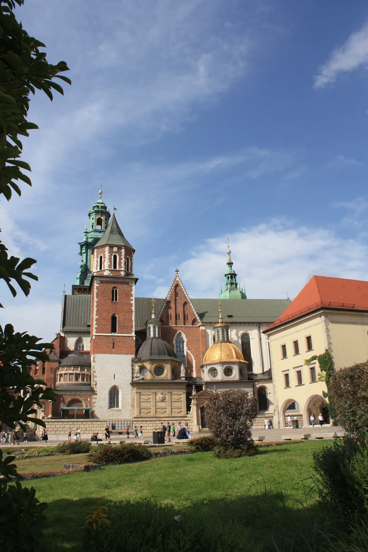 Wawel Cathedral in Krakow, Poland, under a clear blue sky surrounded by greenery