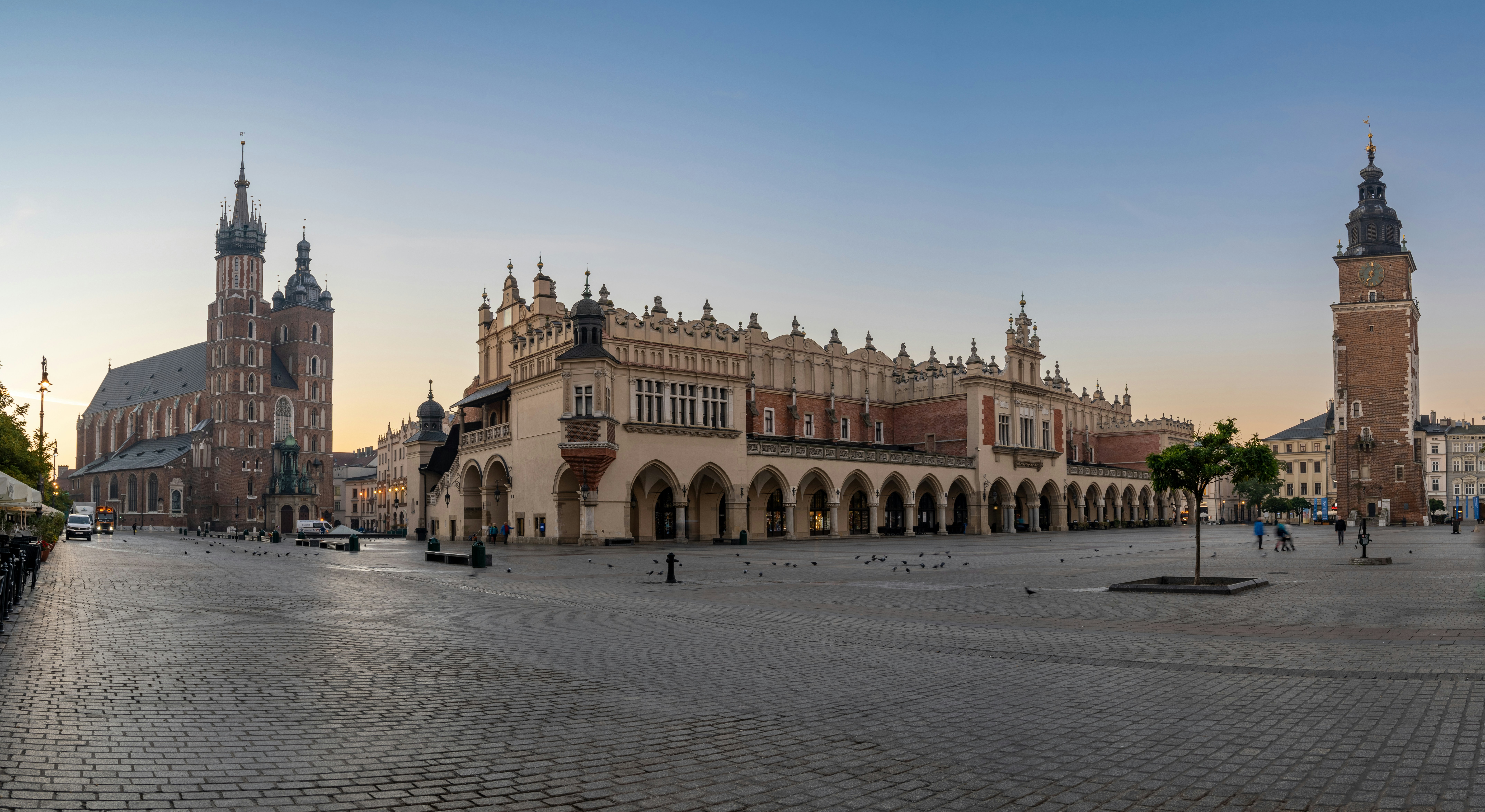 Kraków's Rynek Główny at sunrise — St. Mary's Basilica, the Cloth Hall and Town Hall Tower