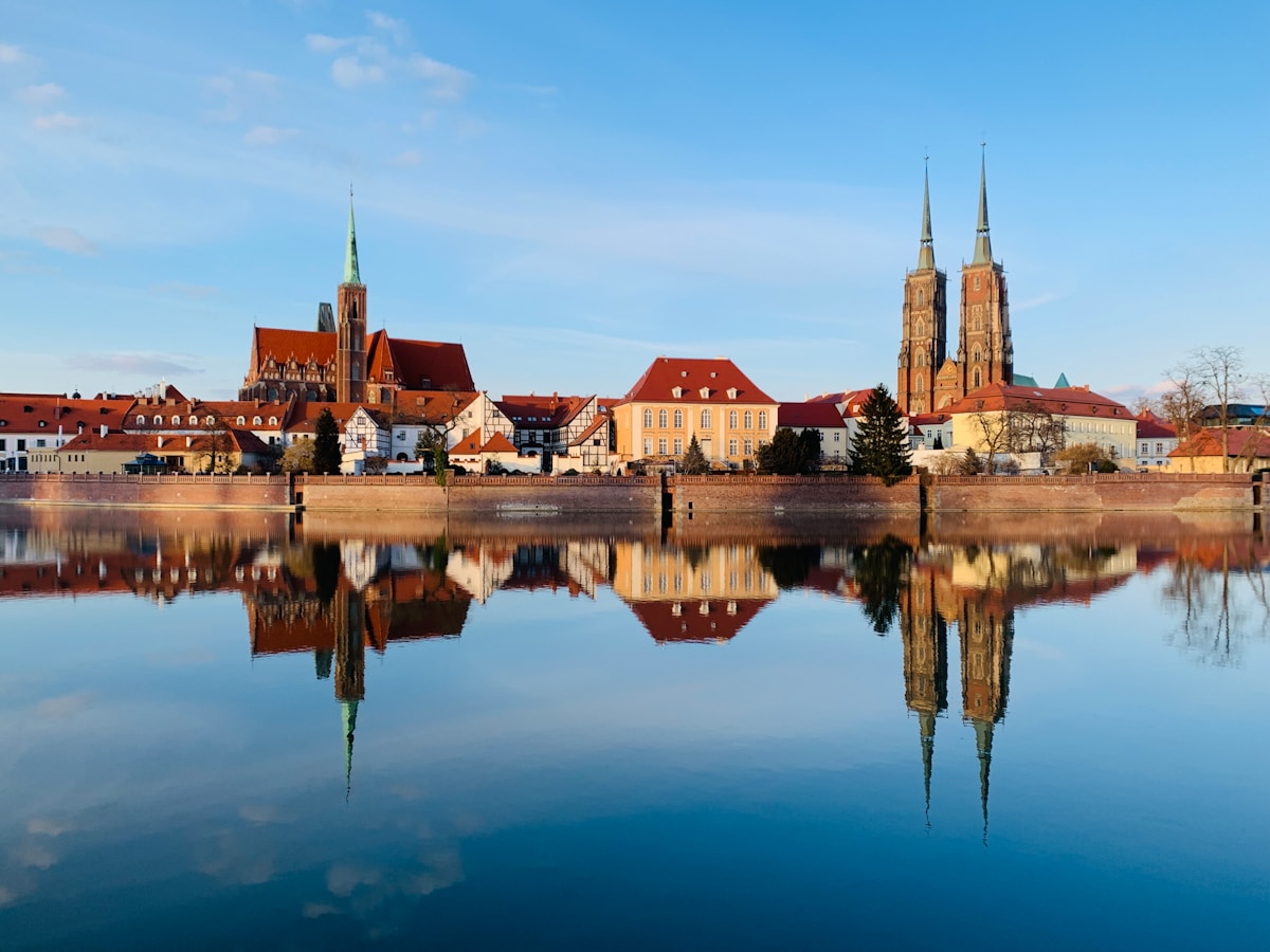 Wrocław cathedral island with twin spires reflected in the Oder River, Poland